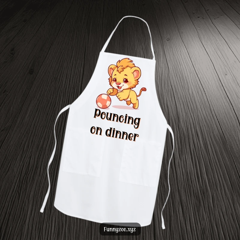 Funny Lion Cub Pounce Apron: Playful apron showcasing a cute lion cub comically pouncing on a bouncing ball.