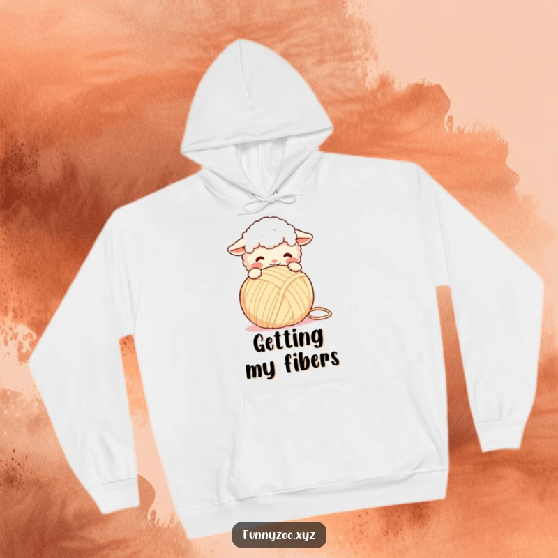 Funny Hoodie: Cute fluffy sheep playfully headbutting a giant yarn ball, a warm and amusing craft graphic.