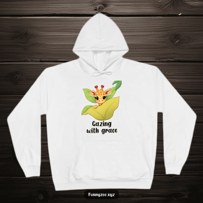 Funny giraffe hoodie with a happy character peeking playfully over a large jungle leaf, offering warmth and humor.