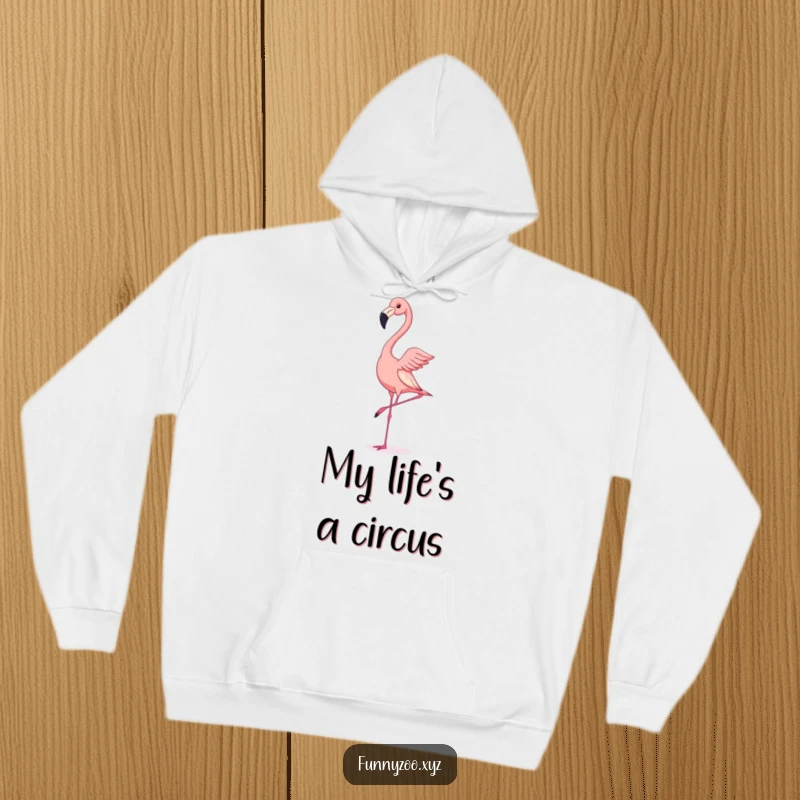 Funny hoodie design capturing a flamingo attempting a handstand with comical instability, perfect for cozying up with a laugh.
