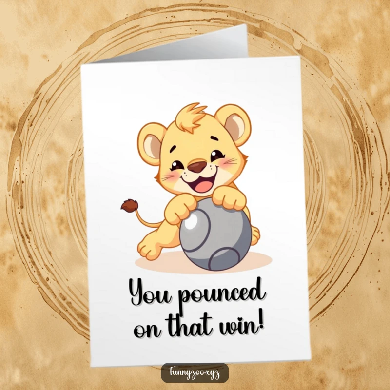 Funny Free Printable congratulations card showing a smiling lion cub leaping playfully onto a rolling ball.