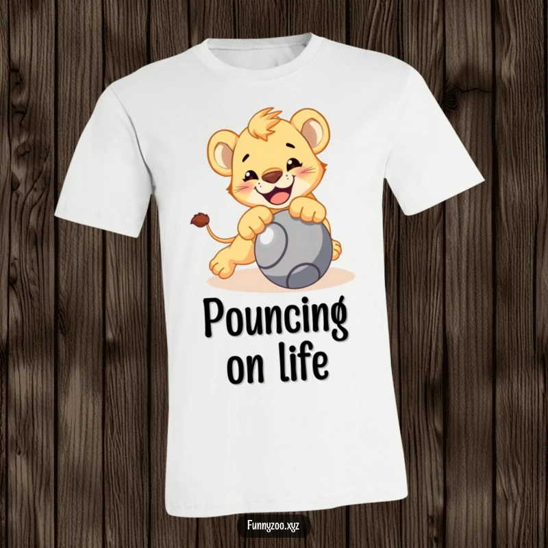 Funny lion cub t-shirt, character playfully pouncing on a rolling ball, energetic and bold, great funny gift.